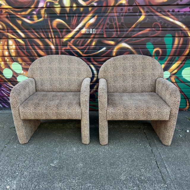 This is a pair of 1980s cheetah print accent chairs.