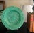 English majolica bowl set in a vibrant green, made around 1900. The center features fruit and flowers.