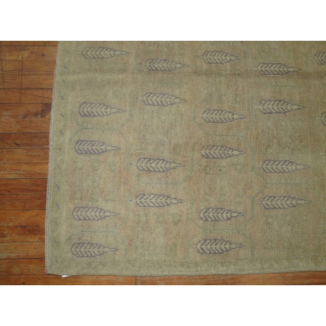 Vintage Turkish Oushak rug with an-all-over cypress tree branch design on a beige color field. Accents in lavender and...