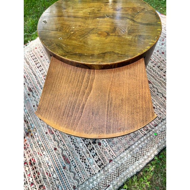 A striking round mid-century modern drum nightstand or side table in bookmatched olive burlwood veneer, Italian-made,...