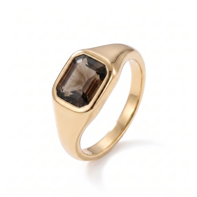 A modern interpretation of the classic signet ring, this elegant design showcases a rich smoky quartz in a sleek bezel...