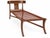 Sophisticated modern chaise lounge in the manner of Robsjohn Gibbings Klismos. The chaise has a walnut finish, with...