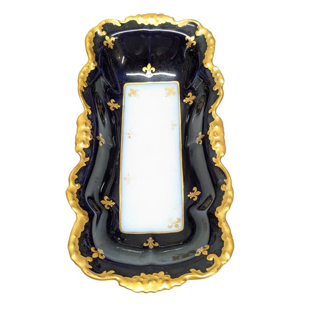 Royal velvet blue and thick gold gilt on soft paste porcelain tray. Some of the hand painted Fleur de Lis are wearing off...