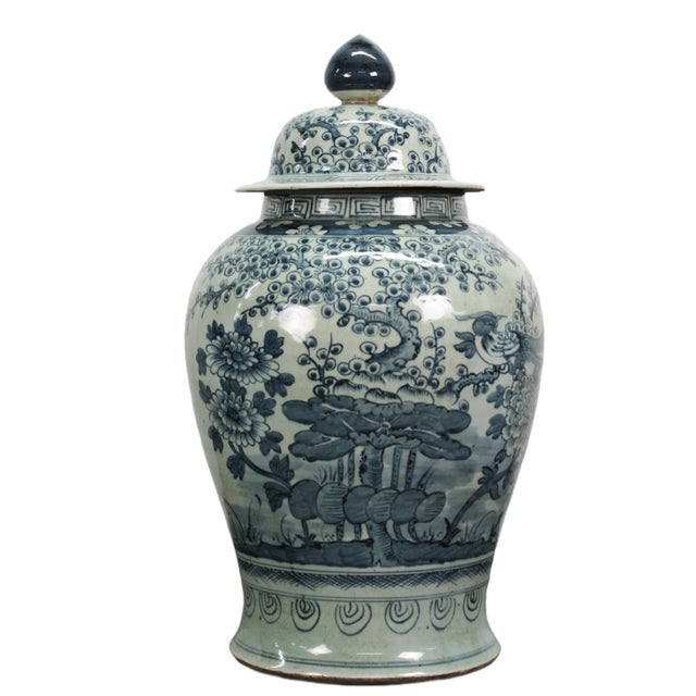 This gorgeous blue and white porcelain jar is adorned with beautifully hand painted peonies, red plum and lovely bird....