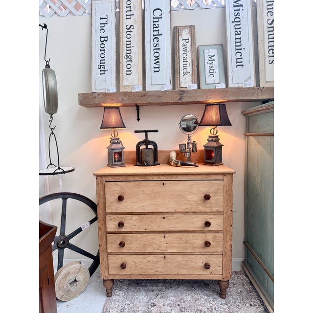 This 19th‑century scrubbed pine chest of drawers carries that unmistakable quiet dignity of early American craftsmanship —...