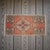 This vintage Oushak mat radiates a warm, sun-faded charm with its earthy terracotta field and traditional Anatolian...