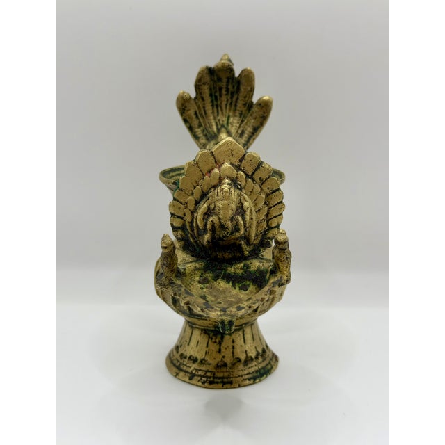 This vintage metal oil lamp appears to be a Sukunda-style ritual lamp, a form traditionally used throughout the Himalayan...