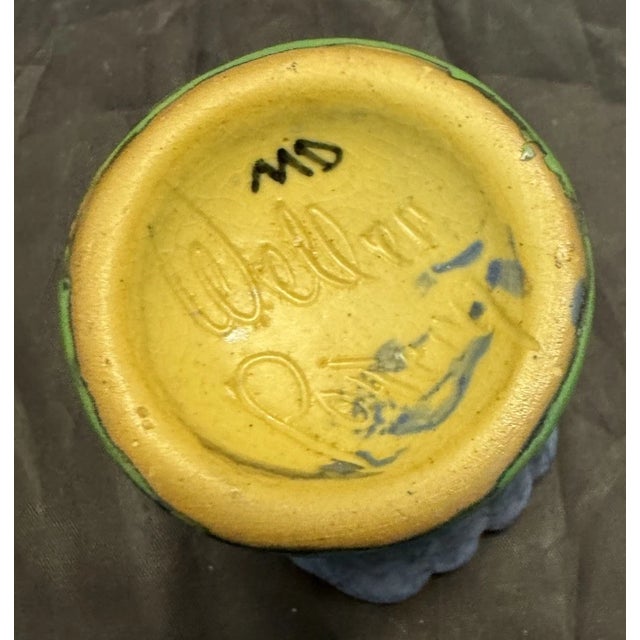 The Weller Fan Vase is a beautifully crafted piece of pottery with a blue speckled top and green base. This vase features...