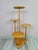 A decorative, multi-level flower stand made of wood in a warm, natural color. The structure consists of several round...
