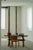 A beautifully handcrafted rustic dining table in solid pine, showcasing the organic character and quiet elegance...
