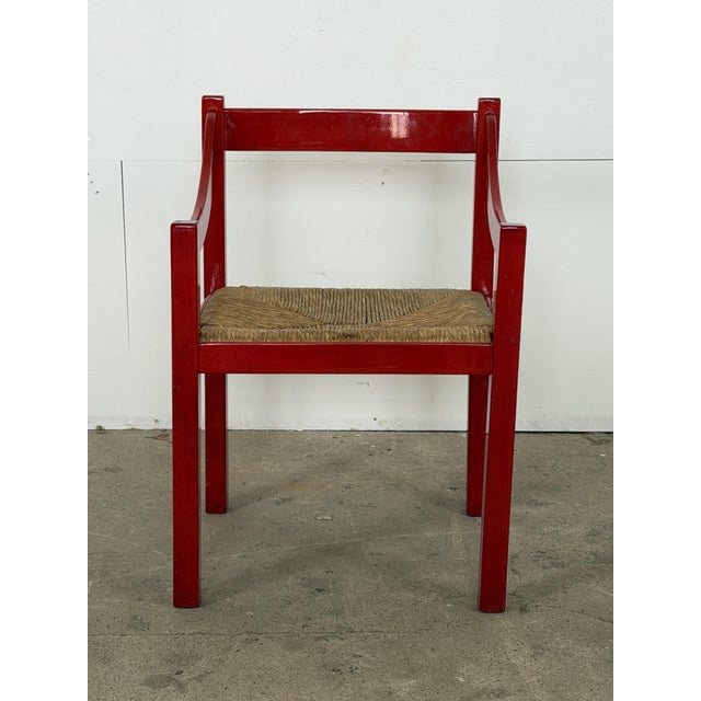 Italian Carimate armchair in red lacquered beech, designed by Vico Magistretti for Cassina, 1960s. The frame is...