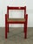 Italian Carimate armchair in red lacquered beech, designed by Vico Magistretti for Cassina, 1960s. The frame is...