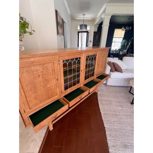 Danish oak sideboard with leaded glass doors, early-to-mid 20th century. Beautifully figured quartersawn oak throughout,...