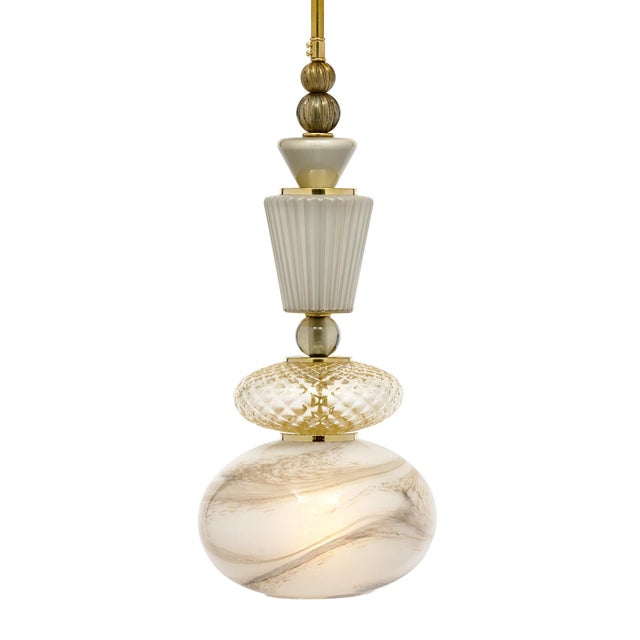Pair of Murano glass pendants in the style of Ettore Sottsass. This pair includes hand-blown glass elements in a variety...