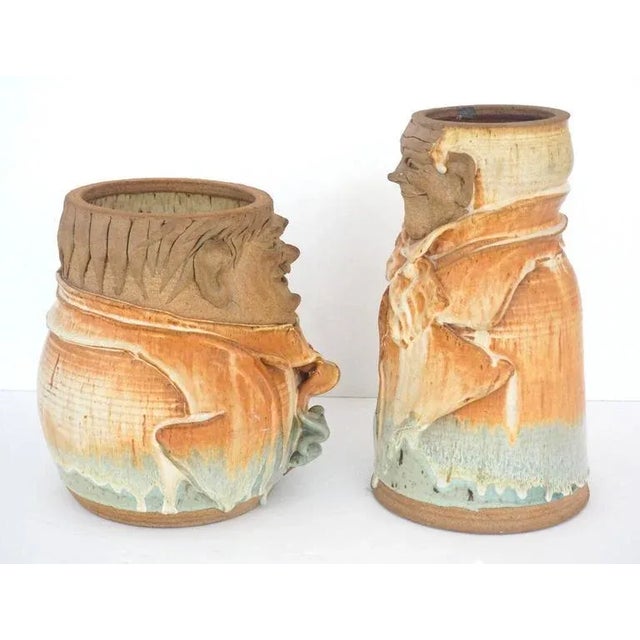 This set of artisan created earthen ware pottery vases are in the stylized forms of the American film actors Laurel and...