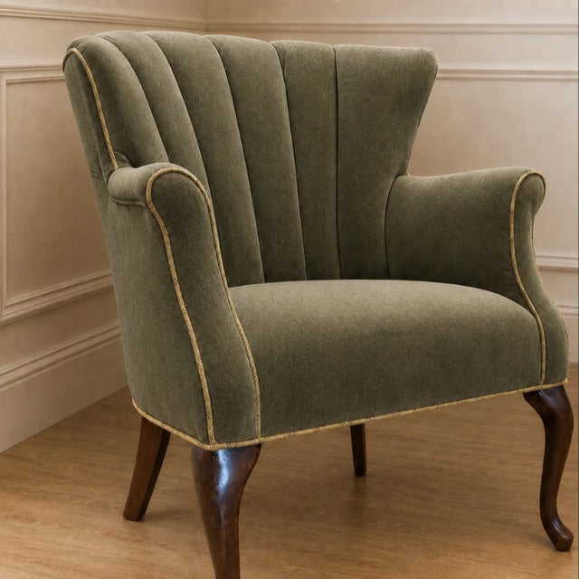 This elegant accent armchair embodies refined traditional craftsmanship with a soft contemporary sensibility, making it a...