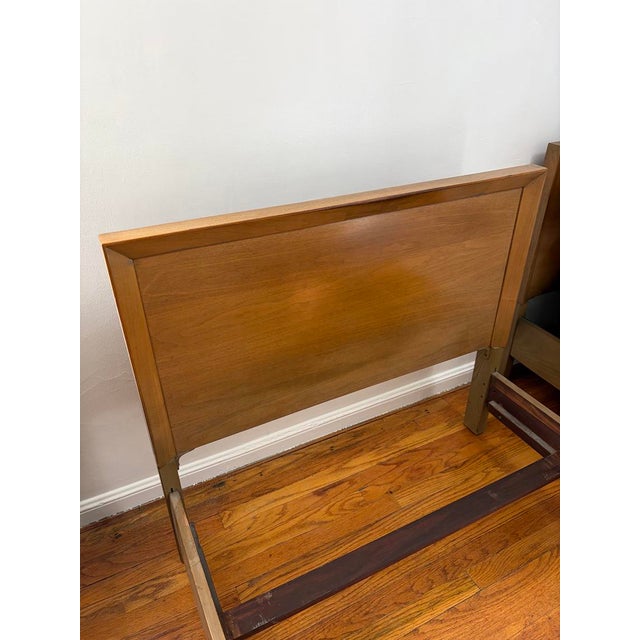 A Mid-Century Modern all original twin bed frame and headboard in pristine condition with only minor wear to the finish.