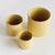 With a crackled glaze, uneven texture and basic form, this set of cachepots is simple and raw. In a refreshing buttercup...