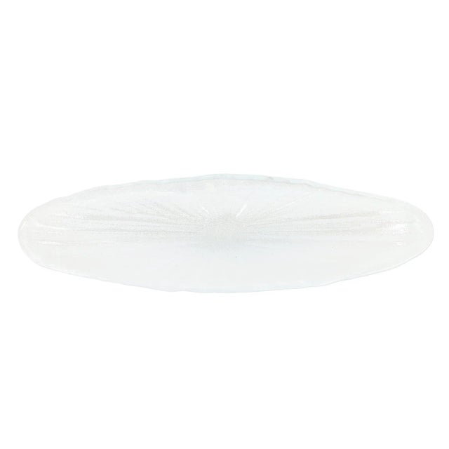 Reminiscent of the waves crashing on the island of Capri, the organic shape of the Onda Glass White Long Oval Bowl mimics...