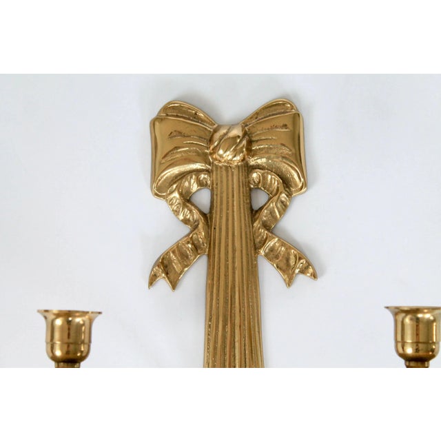 Vintage brass wall sconce with double taper candle holder, ornate bow and curtain tassel motif. No makers mark. Minor age...