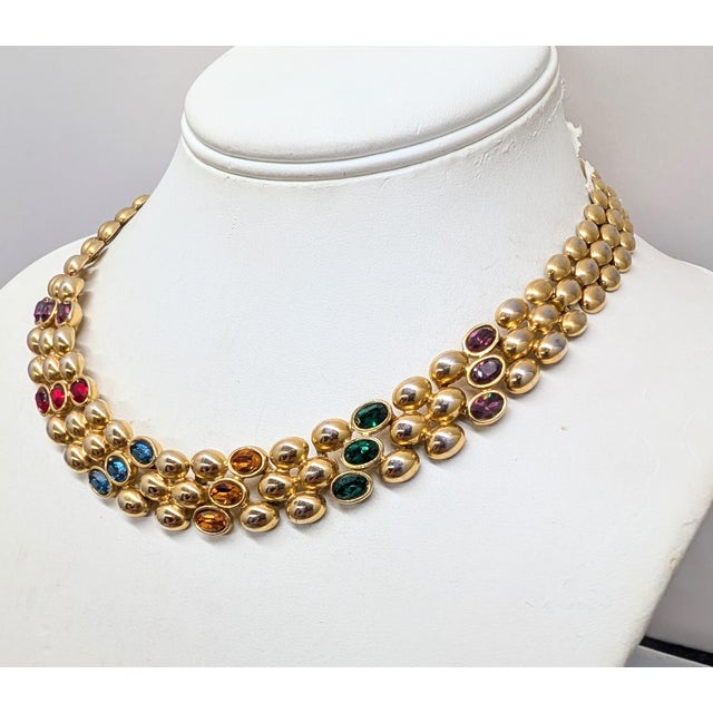 Circa 1991 goldtone offset oval domed in lines of 3 with oval faux-amethyst, emerald, citrine & sapphires articulated...