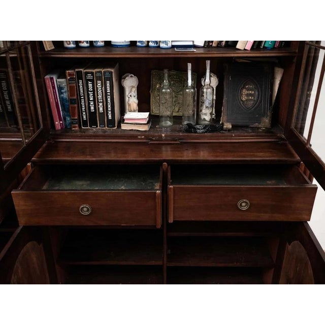 English bookcase made of solid mahogany in the style of Thomas Chippendale. The upper glass part with divided glass, the...
