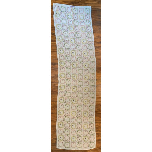 This is a vintage Salvatore Ferragamo silk scarf featuring a white background with a repeated floral wreath and butterfly...