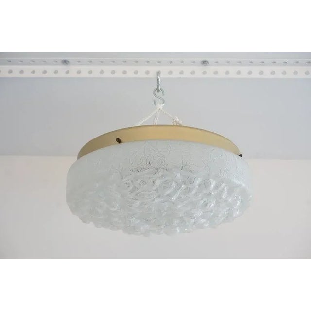 Mid-Century Modern Doria Leuchten Flush Mount Chandelier in Crackle Glass and Brass from a Palm Beach estate.. This...