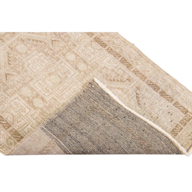 Beautiful Antique Turkish Sivas Handmade Wool Runner with a beige field. This piece has an ivory accent in an all-over...