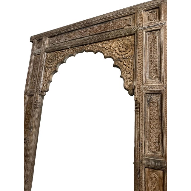 An exceptional antique Jharokha-style arch doorway, hand-carved in India and rich with the ornamental detail this...