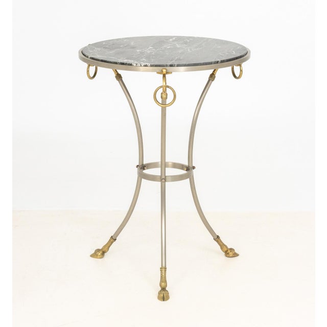Maison Jansen Style Wrought Iron and Brass Occasional Table, with black and white marble top above three scroll form ring...