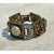 This vintage Victorian-style ornate bracelet is composed of large, richly detailed filigree panels, each showcasing...
