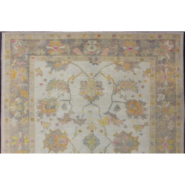 Measures: 8'3 x 10'2 Turkish Oushak rug with array of light and medium tone colors and design, Keivan Woven Arts / rug...