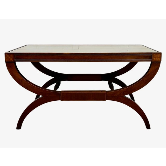 This vintage coffee table features a rectangular wood frame fitted with a removable inset glass top, allowing the...