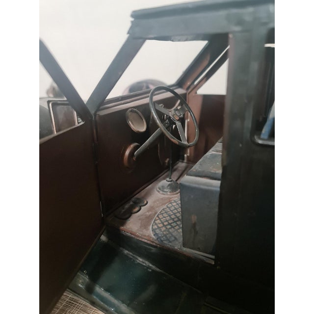 Brown metal vintage car with blue missing a part of headlight