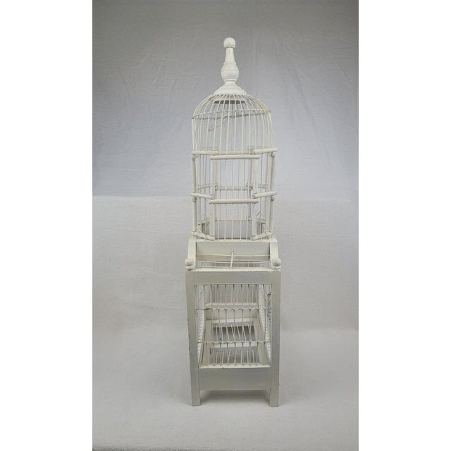 Vintage decorative birdcage crafted from wood and wire with a distressed white painted finish. This two-tier architectural...