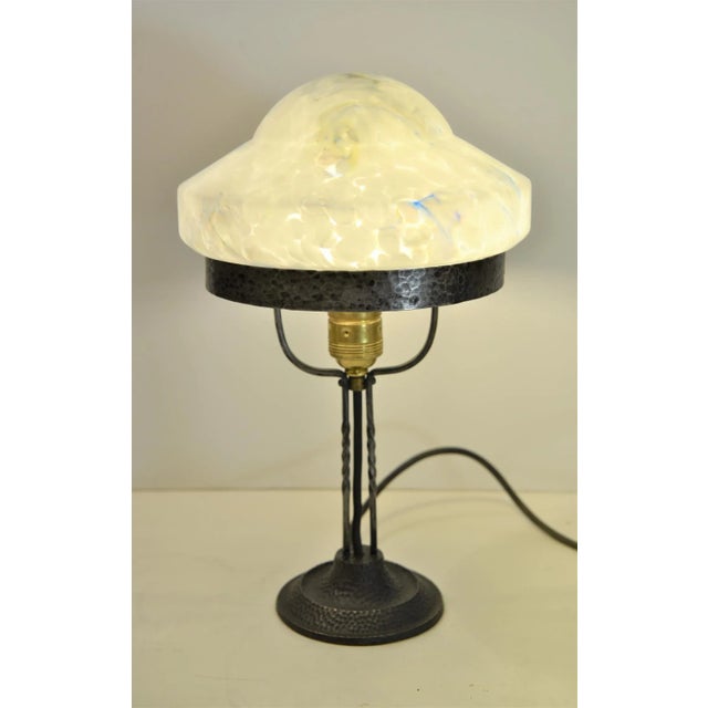 Wrought iron and glass table lamp made in Sweden in the 1920s. The lamp is very simple in the design but yet very...