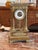 A French gilt bronze portico clock labeled “French Gilt Bronze Portico Clock,” constructed with four fluted column...
