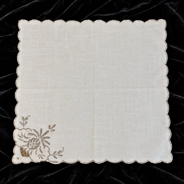 Beautiful vintage-style cotton napkins featuring delicate gray floral embroidery and graceful scalloped edges. Their...