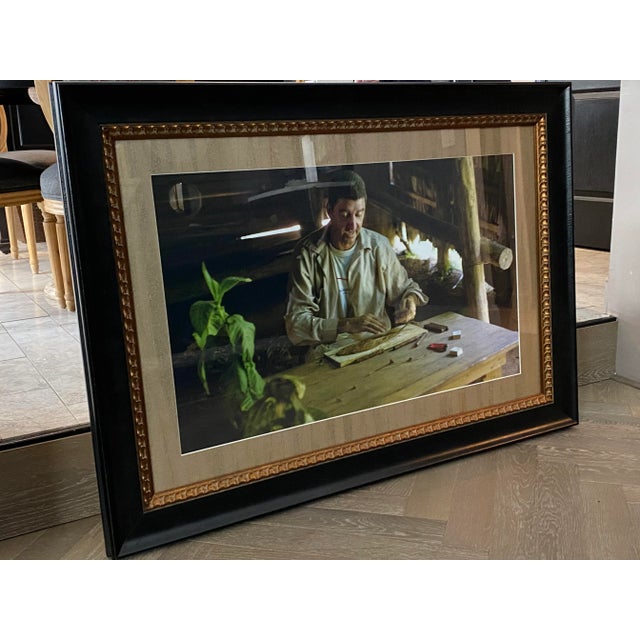 Custom framed original photo of an authentic cigar roller in Cuba, specially matted with Maya Romanoff wallcovering. Frame...