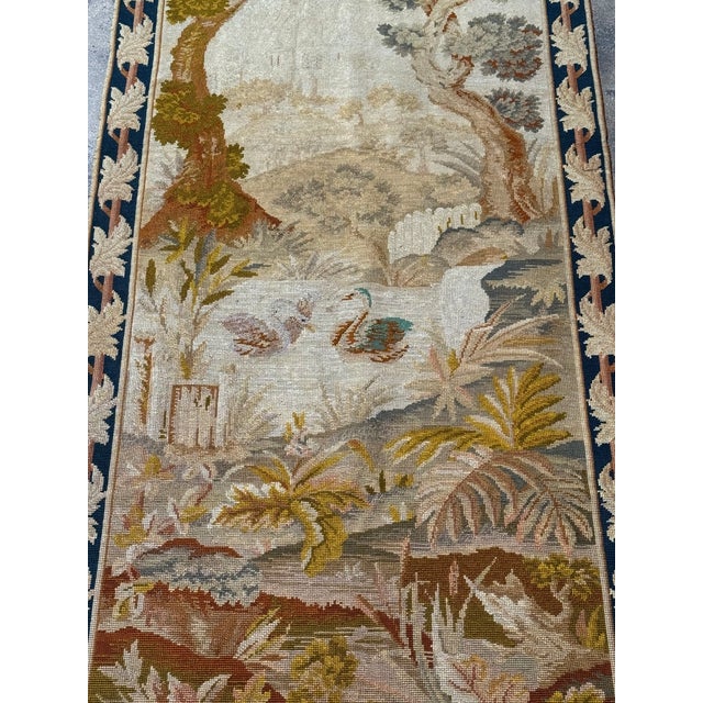 This antique English needlepoint tapestry runner dates to the early 20th century, circa 1920, and features a finely...