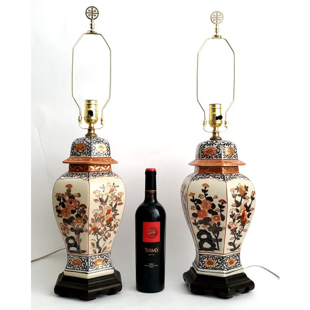 Offering a pair of Imari Japanese porcelain table lamps, circa 1960s. These Ginger Jar or Temple Jar shaped lamps have...