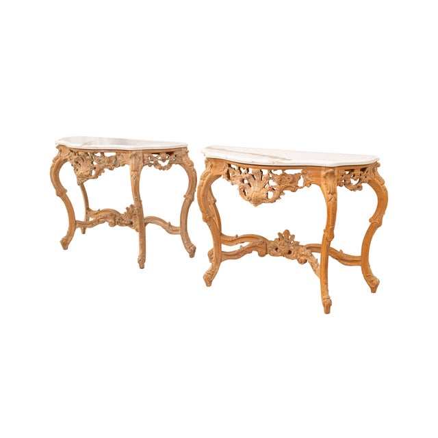 Presented is a stunning pair of vintage hand-carved Baroque style wood console tables with newly added Calcutta Quartz...