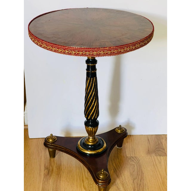 Splendid walnut inside round table with beautiful two wood inlay top, column base on tragere legs. Gold tone and bronze...