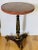 Splendid walnut inside round table with beautiful two wood inlay top, column base on tragere legs. Gold tone and bronze...