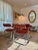 A Set of 4 Chrome Cantilevered Dining Arm Chairs in a Rich Rusty Red Boucle For Sale - Image 10 of 12