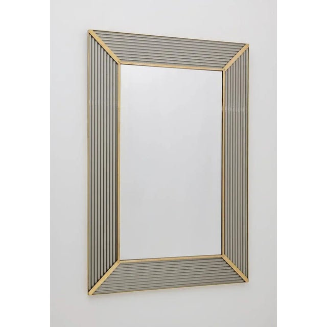 Mirror with gray Murano glass frame, with brass molding, the mirror structure is made of wood. The mirror can be hung both...
