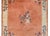 A chic early 20th century Chinese Mandarin rug with a pale orange field with a cream colored striped border with a central...
