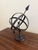 A beautifully crafted iron armillary sphere, evoking the timeless elegance of classical European gardens. Pieces like this...