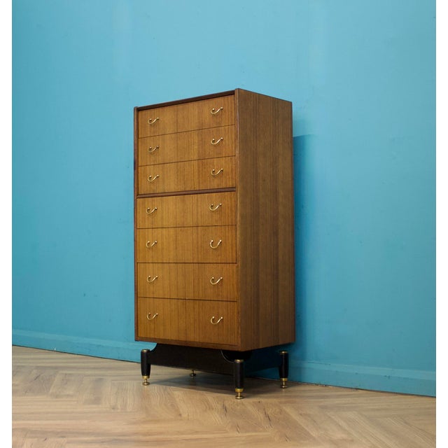 A mid-century G Plan Tola tallboy chest of drawers, dating to the 1950s. Featuring seven drawers and finished in warm tola...